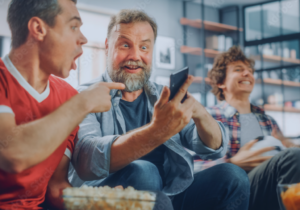 Friends enjoying a shared moment on a smartphone together, representing connection and everyday mobile use