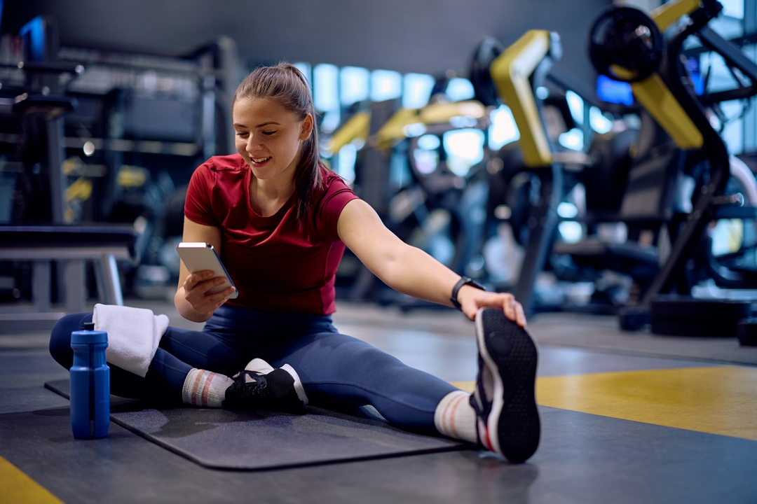 Person staying connected on their phone while exercising, highlighting flexible mobile use in everyday life
